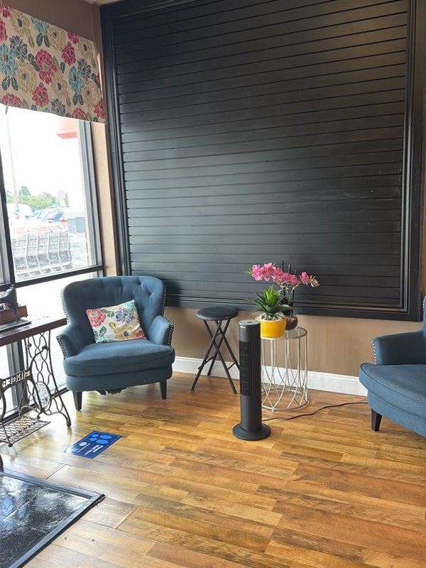 Comfortable waiting area with armchairs inside the shop